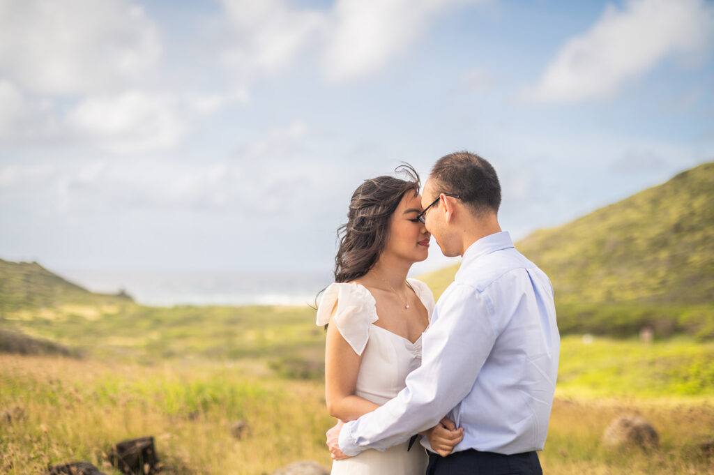 Couple facing each other in a beautiful green hillside in Hawaii