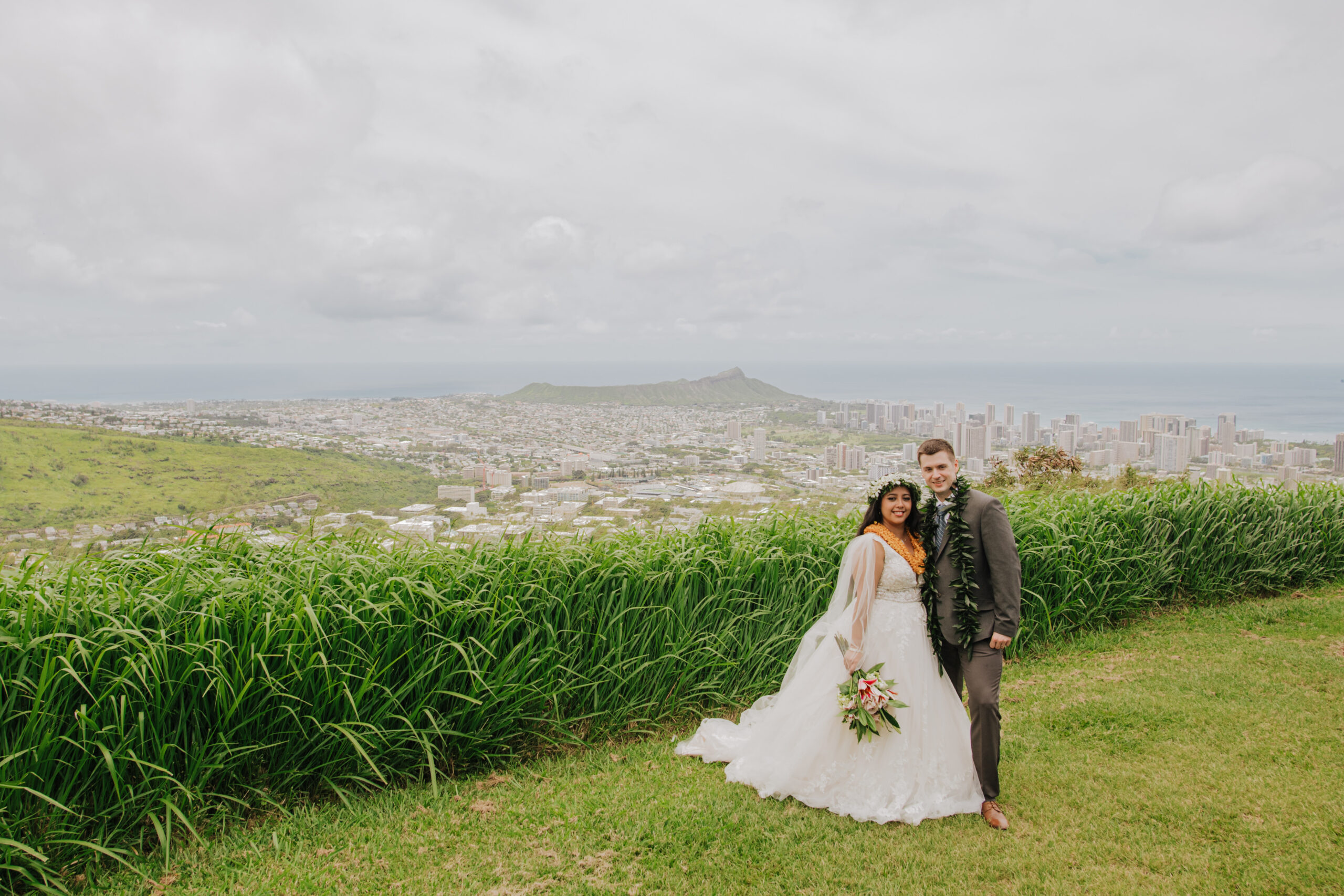 Bride and groom with Waikiki in the background